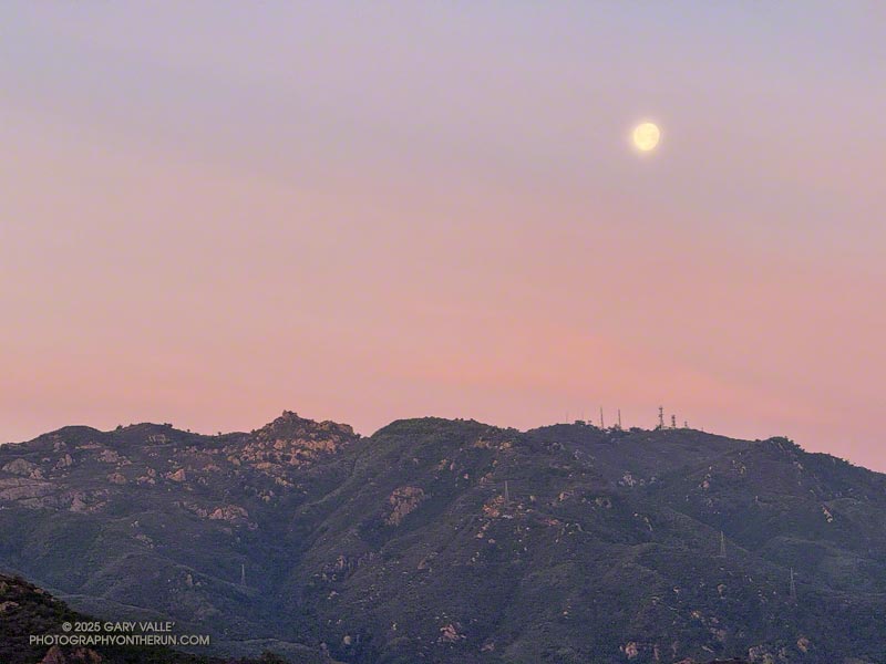 The moon sets above the top of Bulldog Mtwy (left) and Castro Peak (right). March 16, 2025.
