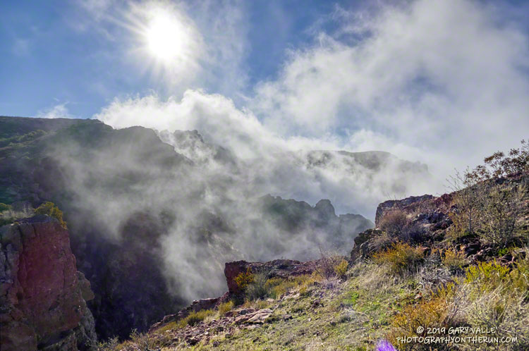 Clouds spilling over the lip of Boney Mountain's western escarpment. This is about three-quarters of the way up the western ridge.