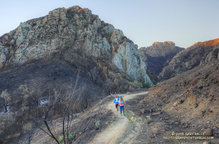 Ann and Skye on the Lookout Trail near Crags Road. Goat Buttes are in the background.
