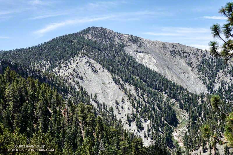 A midday view of Pine Mountain from the PCT. The flat exposure of Pelona Schist on the northwest flank of Pine Mountain reflects the sun like a sheet of ice.