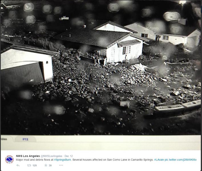 Tweet from NWS Los Angeles/Oxnard at 2:43 am with photo of large mud and debris flows affecting homes below Conejo Mountain on the northwest border of the Springs Fire burn area.