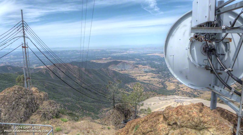 Congested summit of North Peak. Eagle Peak is behind the wires on the left and the Mitchell Canyon Trailhead is at the base of the ridge descending from Eagle Peak.