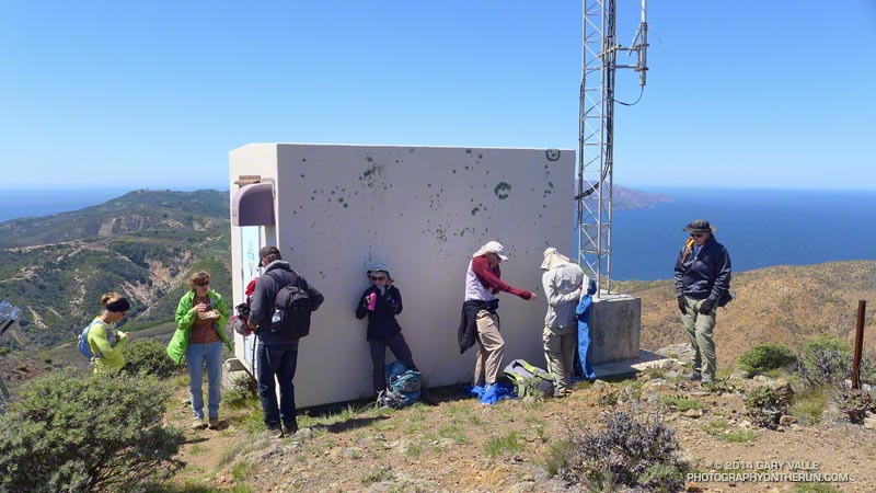 It was a bit windy on the top of El Montañon. The lee side of the comms building was full when Ann and I reached the summit.