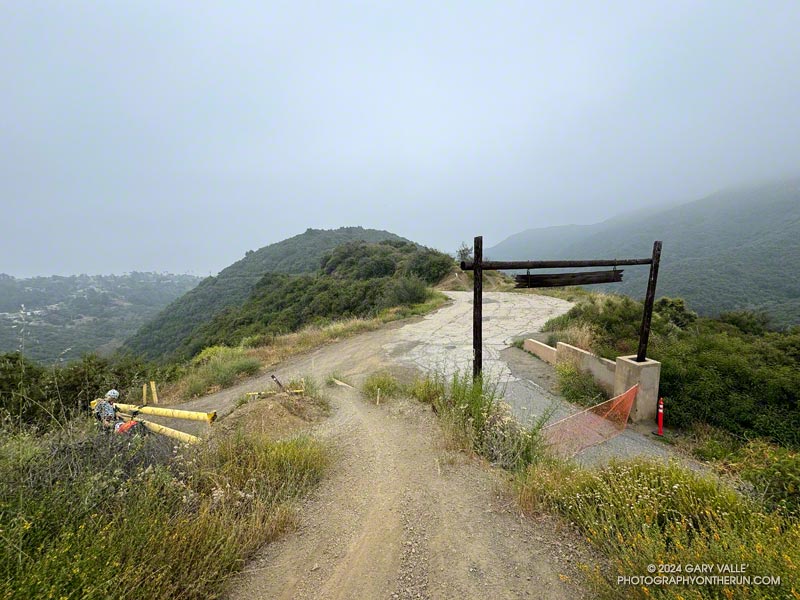 Sullivan Ridge Fire Road is paved south of the yellow fire gate at Camp Josepho junction. The private access road to Camp Josepho is on the right. The Old Stables Trail is about a tenth of mile beyond this point, on the right.