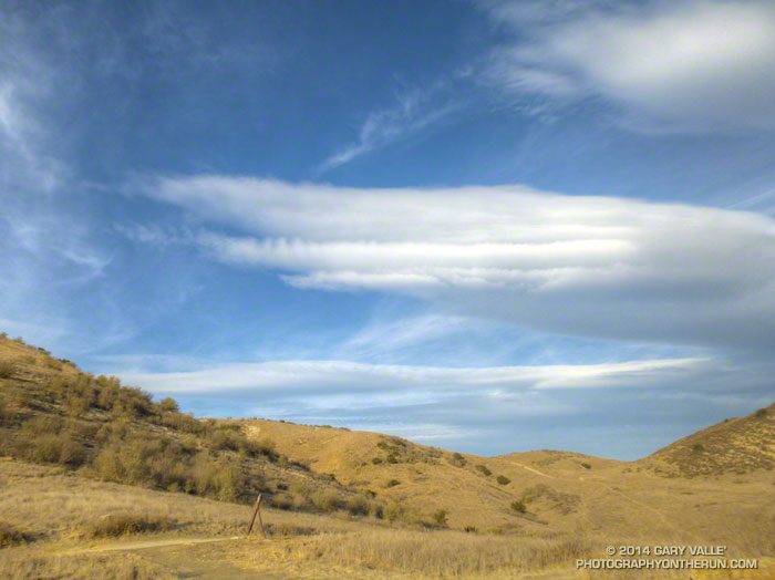 Lenticular wave clouds typically form in the crests of invisible "roller coaster" waves that extend downwind from an obstruction such as a mountain range. Southern California, January 28, 2014.